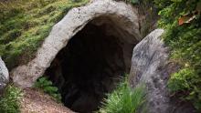 A cave in a grassy hillside
